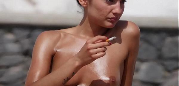  Tanned toned brunette shows off her tits on topless beach